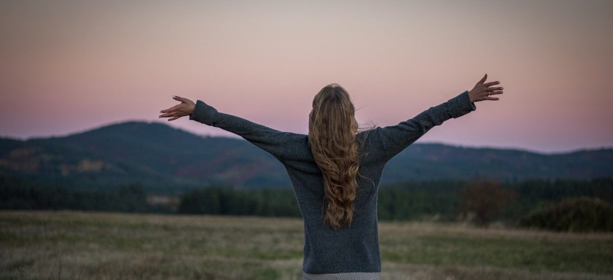 A portrait of a girl from behind just after sunset