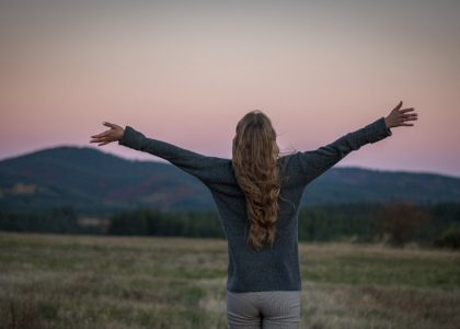 A portrait of a girl from behind just after sunset